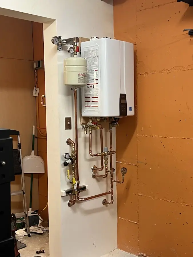 Plumbing technician inspecting water heater connections in Aptos
